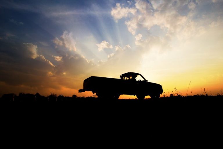 pickup truck insurance - pickup truck silhouette against a sunset